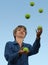 Woman juggling with tennis balls