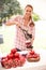 Woman Juicing Fresh Pomegranates At Farmers Market Stall