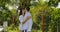 Woman Jump Over Man Couple Embracing And Kissing While Walking In Tropical Garden Near Villa House, Happy Lovers On