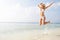 Woman Jumping In The Air On Tropical Beach