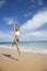 Woman jumping on beach.