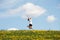 Woman jumping on blossom meadow.