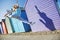 Woman Jumping In Front Of Beach Huts