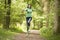 Woman jumping on path smiling