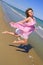 Woman jumping at the sea beach