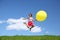 Woman jumps away from grass with large ball