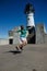 Woman jumps in front of the Canal Park Lighthouse in Duluth Minn