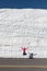 Woman Jumps in front of tall snow drift