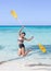 Woman jumps with a paddle on a sea beach