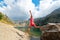 Woman jumps from a rock near a mountain lake