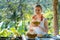 Woman in jungle gazebo sipping on a coconut