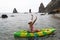 Woman kayak sea. Happy tourist enjoy taking picture outdoors for memories. Woman traveler posing in kayak canoe at sea