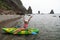 Woman kayak sea. Happy tourist enjoy taking picture outdoors for memories. Woman traveler posing in kayak canoe at sea