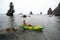 Woman kayak sea. Happy tourist takes sea photo in kayak canoe for memory. Woman traveler poses amidst volcanic mountains