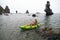 Woman kayak sea. Happy tourist takes sea photo in kayak canoe for memory. Woman traveler poses amidst volcanic mountains