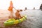 Woman kayak sea. Happy tourist takes sea photo in kayak canoe for memory. Woman traveler poses amidst volcanic mountains