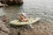 Woman kayak sea. Happy woman kayaks in sea, capturing outdoor memory with happy tourist taking photo. Volcanic mountains