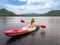 Woman kayaking on lake