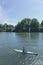 A woman is kayaking and a man is sailing on the River Thames in London