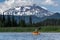 Woman kayaking mountain lake