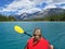 Woman kayaking with red inflatable kayak on Edith Lake, Jasper, Rocky Mountains, Canada