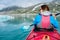 Woman kayaking on Styggvatnet glacier lake near Jostedalsbreen glacier.