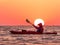 Woman kayaking at sunrise