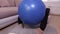 Woman keeping with legs fitness ball and doing exercise