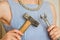 Woman keeps a hammer and a spanner concept against stereotypes