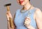 Woman keeps a hammer and a spanner concept against stereotypes