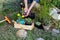 Woman keeps marigold tagete seedling in the palms and prepares plant it in the rockery