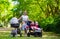 Woman with kids in stroller in a park