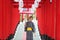 Woman in kimono holding umbrella walking into at the shrine red gate, in Japanese garden.