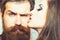 Woman kiss hipster with long beard, love. Sensual woman with makeup skin and bearded man. Couple in love and family