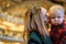 Woman kissing child in church on Christmas Eve