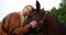 Woman kissing horse on wooden fence at ranch 4k