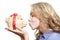 Woman kissing piggy bank