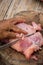 Woman in the kitchen cooking roast pork: cutting meat.