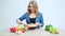 Woman in the kitchen cuts vegetables for a diet salad