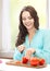 Woman in the kitchen cutting tomatoes