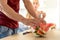 woman in a kitchen eating red watermelon and looking at her husband, Couple in their large contemporary white kitchen