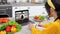 Woman in kitchen greets study online video call laptop listen chef writes