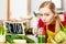 Woman in kitchen having green detox vegetables