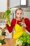 Woman in kitchen holding vegetable celery smoothie juice