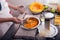 Woman in kitchen making prepares a pie with pumpkin