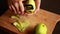 woman in the kitchen peels apples for apple cake