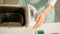 A woman in the kitchen prepares bread in a bread maker