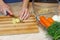 Woman In Kitchen With Roast Chicken. Young housewife making salad