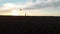 A woman with a kite runs beautifully on the field against the background of the sunset. Smooth aerial shot