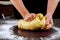 Woman kneading dough for making buns